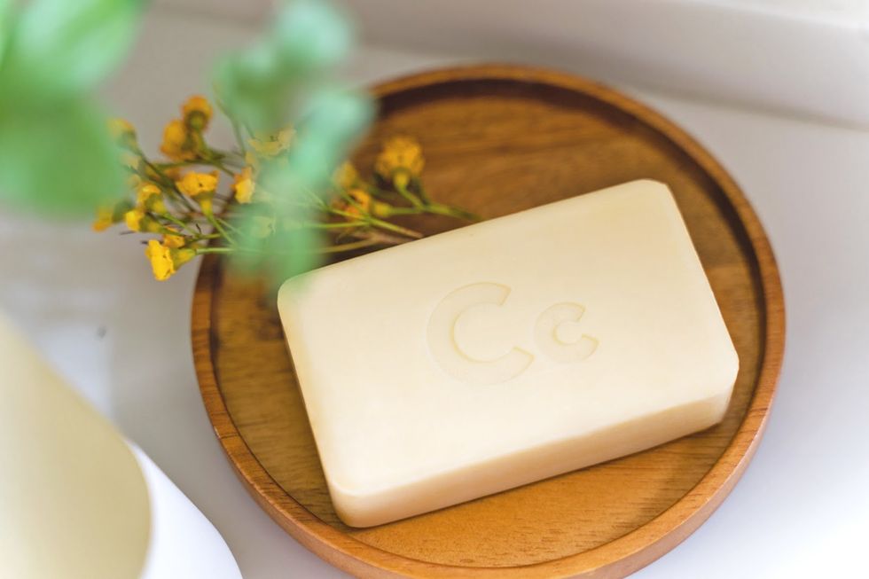 bar of white soap with cleancult logo on a wooden circle