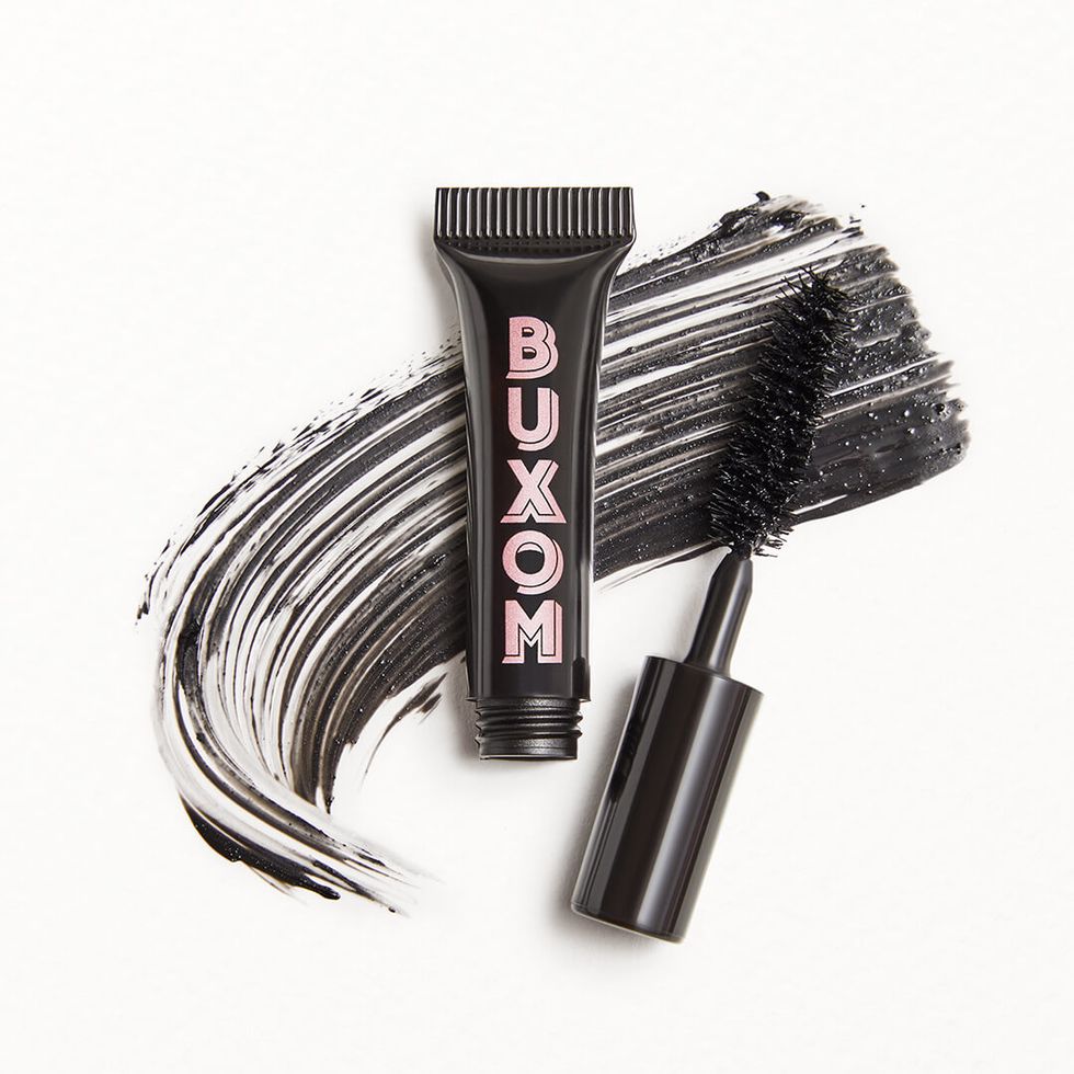 BUXOM COSMETICS Xtrovertu2122 Lifting Mascara next to formula on background