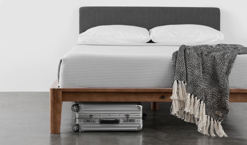 Thuma bed with suitcase underneath